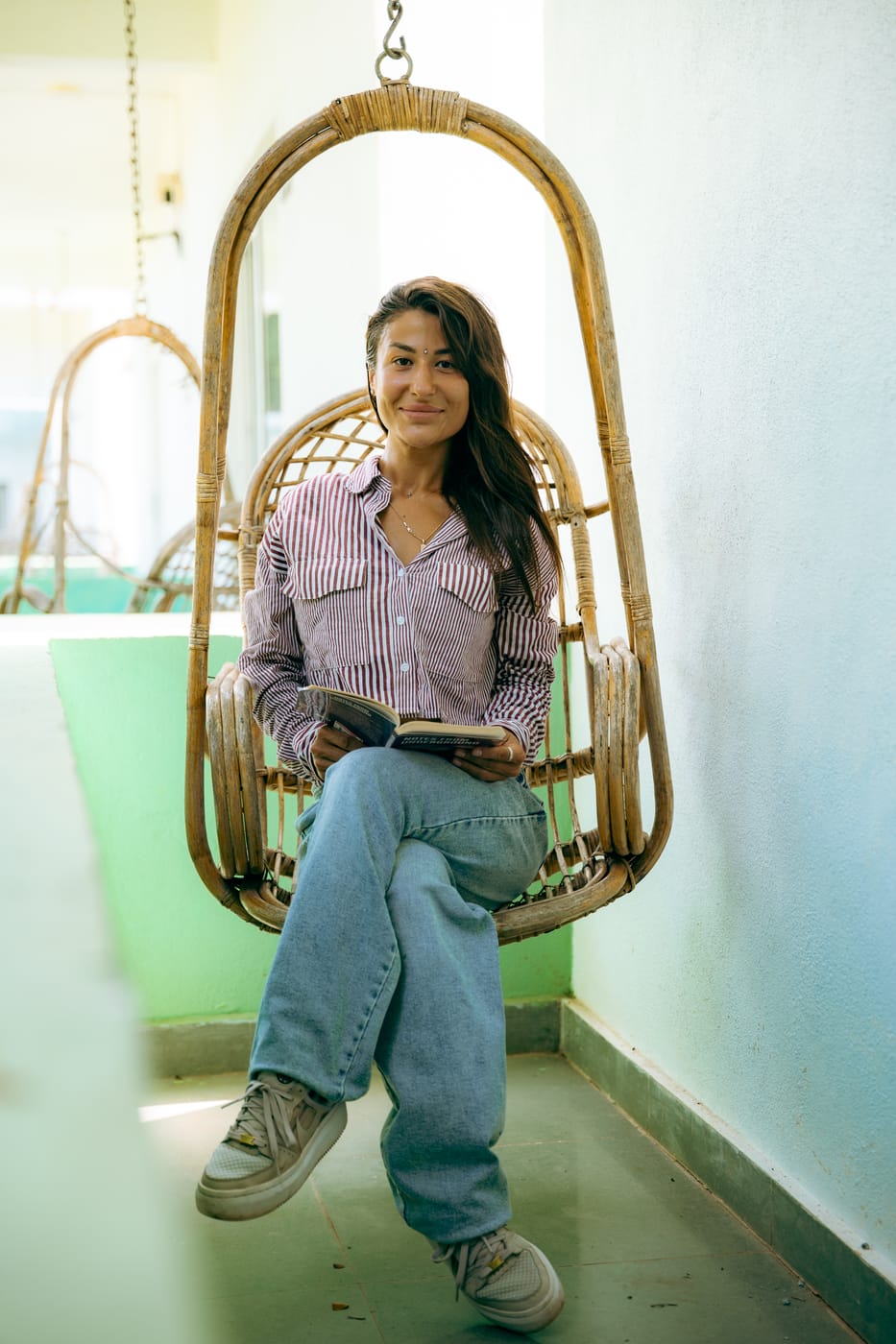 Reading in the hanging chair at Gaia, Morjim