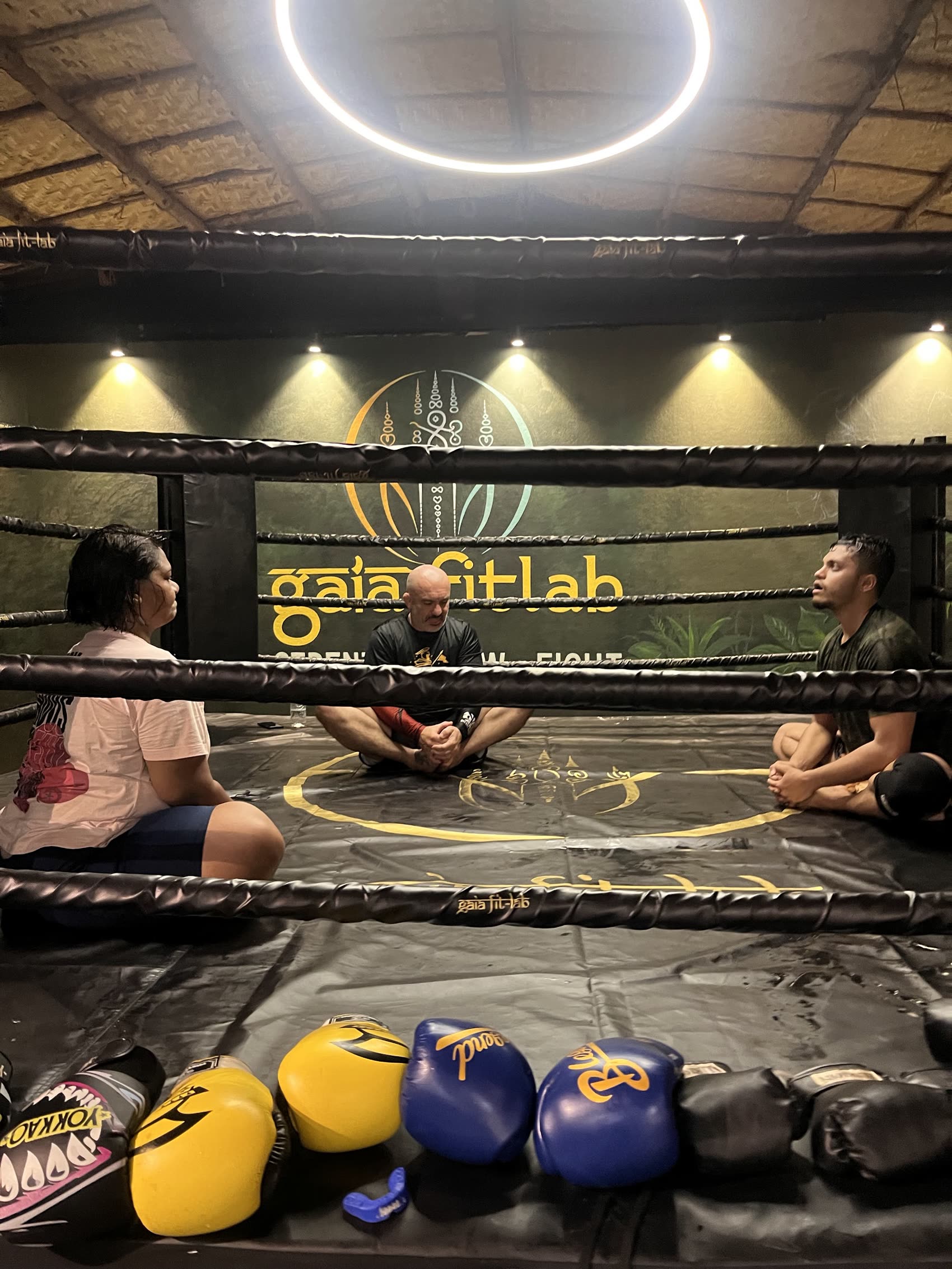 Coach and fighter talking in the ring corner at Gaia Fit Lab