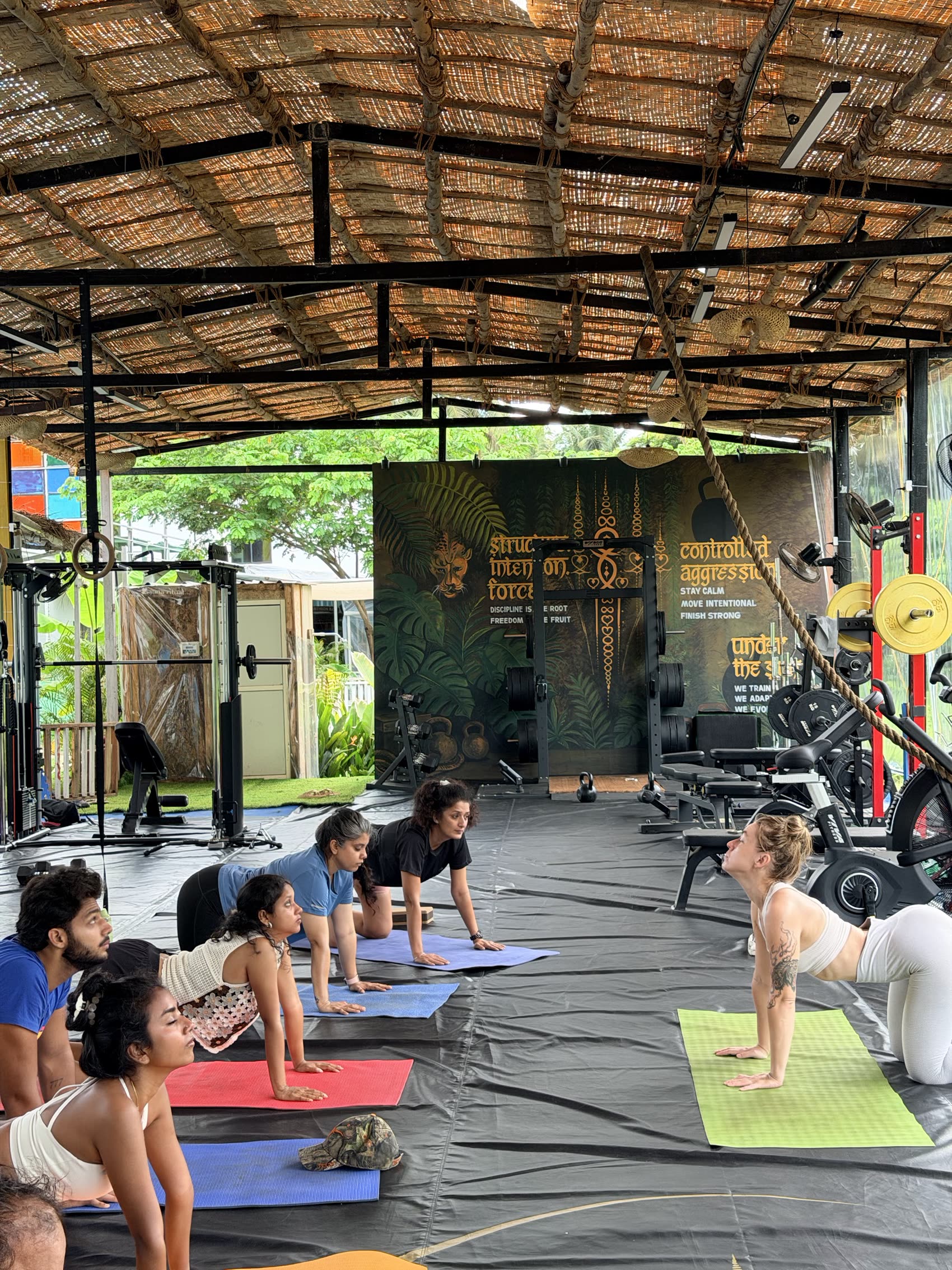 Group yoga and mobility class on mats at Gaia Fit Lab